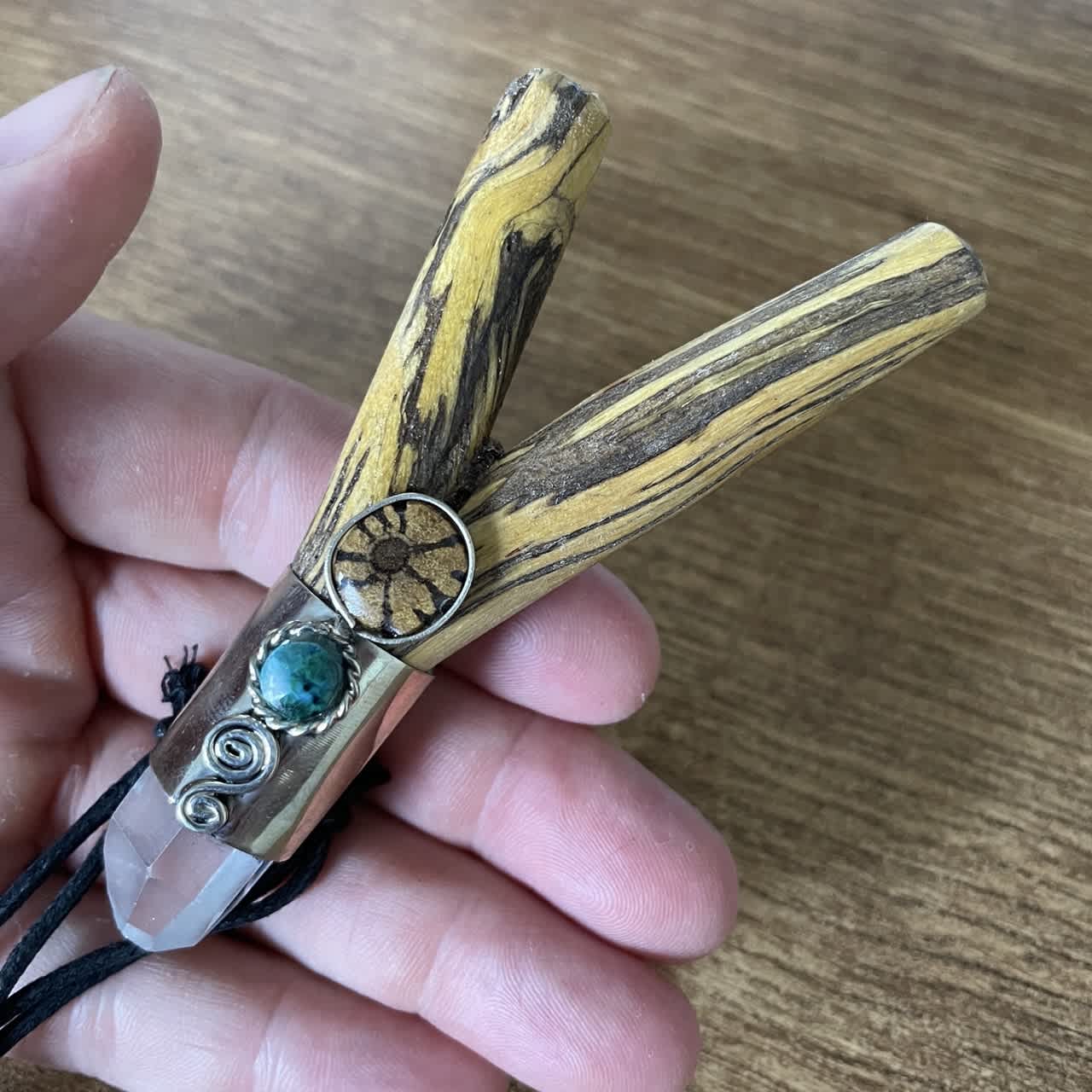 Kuripe Palo Santo Crystal held in the hand &ndash; size comparison